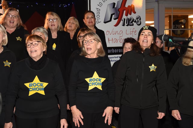 The Rock Choir perform during the Christmas light switch on.