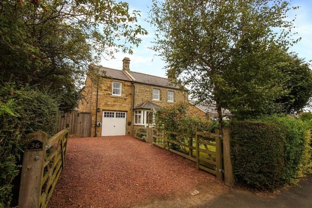 To the front is a beautiful well established garden and a spacious driveway with access to a garage.