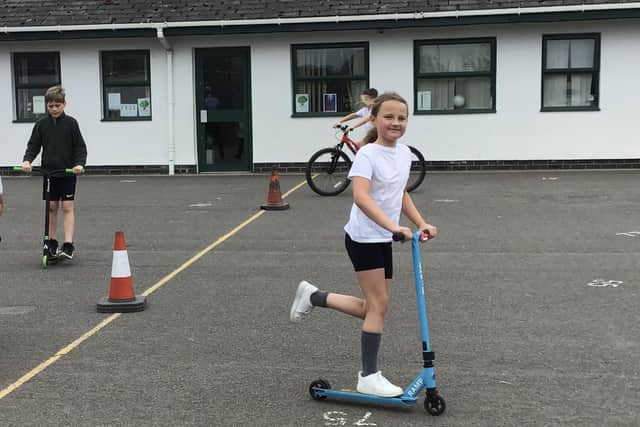 Children scooted, pedalled and hot-footed it around the playground.