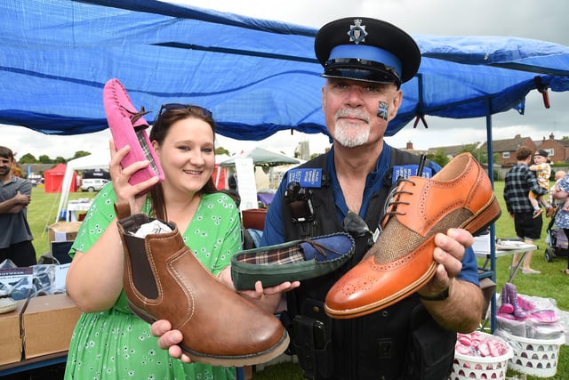 Jodie Goode of Barnwell footwear tries to tempt Police Community Support Officer Steve Adams to some shoes during the Harborough carnival.