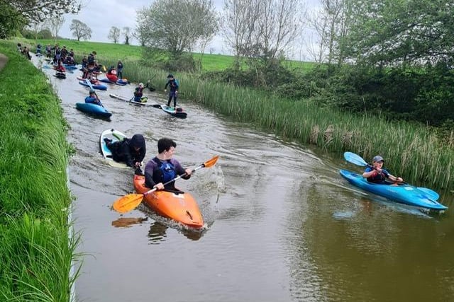 Volunteers from Market Harborough Sea Cadets led over 25 cadets down the Grand Union Canal on Bank Holiday Monday, as part of the nationwide ‘The Big Help Out’ to celebrate the coronation of King Charles III.
The flotilla of stand up paddle boards (SUP), kayaks and even a ‘mega SUP’ travelled the six miles from Harborough’s Union Wharf basin to Foxton, accompanied by parents who walked the distance along the canal towpath. Undeterred by frequent rain showers and grey skies, the cadets celebrated their arrival at Foxton Locks with homemade coronation themed cakes, ahead of the start of their outdoor activity programme that runs from May until October.
For more details on how to join the Market Harborough Sea Cadets email marketharboroughseacadets@gmail.com