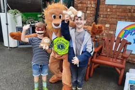 Leo the lion with some happy visitors