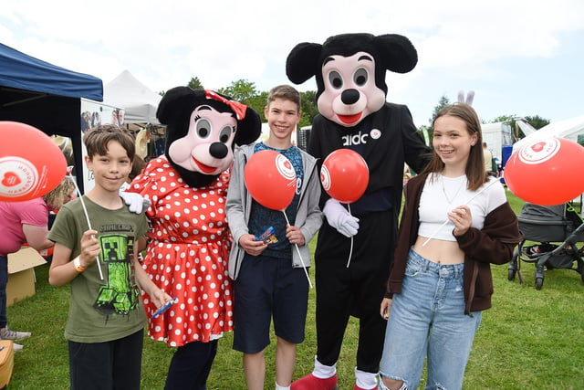 Ben Williams, 11, Joseph Addis, 13, and Alice Williams, 13, meet Minnie and Mickey Mouse of Living Rock Church.