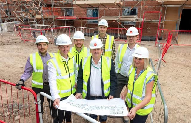 The team gather with Cllr Phil King (centre) to celebrate Care UK's Oat Hill Mew Topping Out Ceremony
