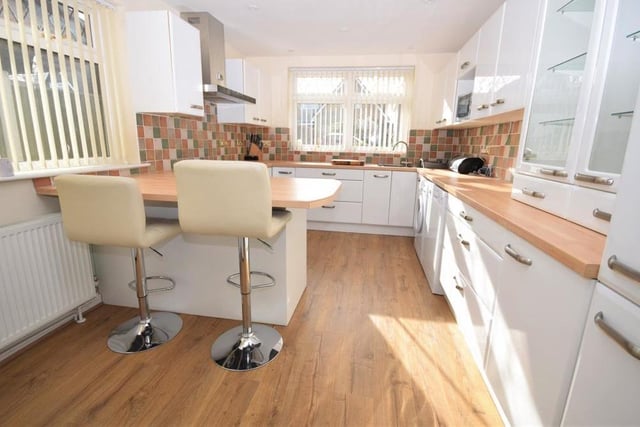 The contemporary kitchen is a sizeable, well-organised space, fitted with a range of modern, stylish wall and base units, giving plenty of storage, and also a useful breakfast bar. There is also ample worktop space, with tiled splashbacks and a one-and-a-half-bowl sink and drainer