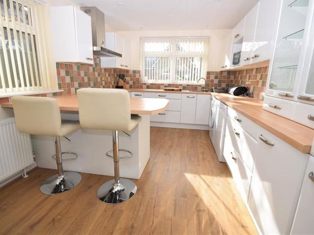 The contemporary kitchen is a sizeable, well-organised space, fitted with a range of modern, stylish wall and base units, giving plenty of storage, and also a useful breakfast bar. There is also ample worktop space, with tiled splashbacks and a one-and-a-half-bowl sink and drainer