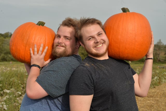 Jack Lewin and Charlie Webb with their giant pumpkins during the Farndon Fields farm shop pumpkin festival.