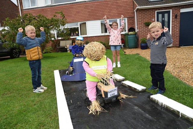 Teddy Gladwell aged four, Isabelle Johnson aged six and Theo Gladwell aged three cheer on the straw racers.