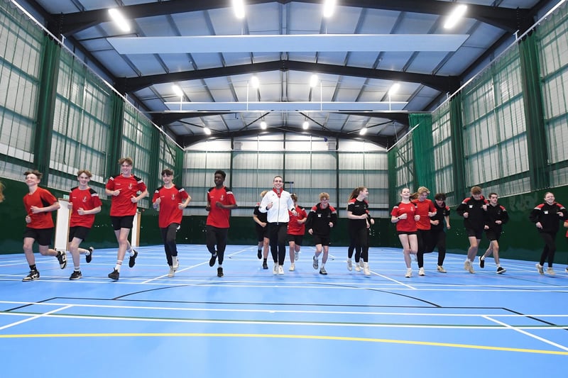 Andrew Stamp tries out the new sports hall at Welland Park Academy with students.