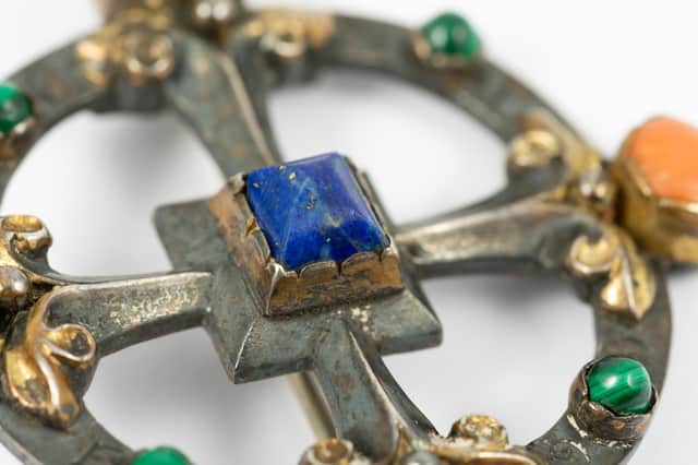 The silver, coral, lapis lazuli and malachite brooch was designed by the great Victorian Gothic Revival designer and architect William Burges, who is best known for designing Cardiff Castle and Castell Coch in South Wales.