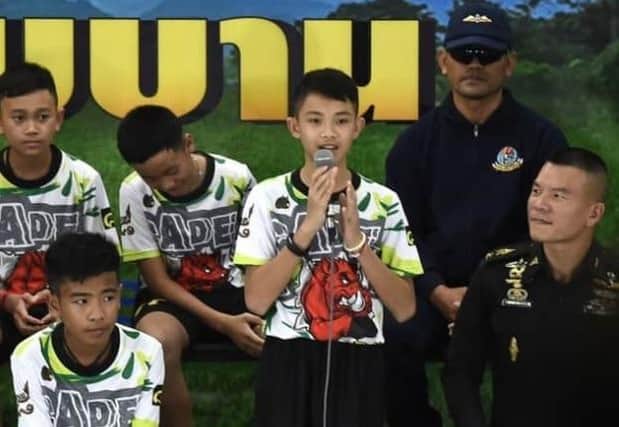 Duangphet Promthep (centre), one of the twelve boys dramatically rescued from deep inside a Thai cave after being trapped for more than a fortnight, speaks during a press conference in Chiang Rai on July 18, 2018, following their discharge from the hospital (Photo: LILLIAN SUWANRUMPHA/AFP via Getty Images)