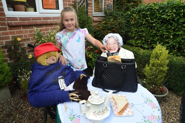 Lottie Stratford aged nine enjoys afternoon tea with Paddington and the Queen.