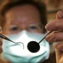 A patient's eye view, as a dentist poses for the photographer.  (Photo by Peter Macdiarmid/Getty Images)