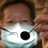 A patient's eye view, as a dentist poses for the photographer.  (Photo by Peter Macdiarmid/Getty Images)
