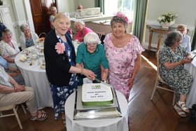 Long-serving member Jean Clarke (centre) cuts the cake with County Chairman, Glenice Wignall and President Susan Woollard.
PICTURE: ANDREW CARPENTER