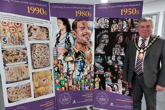 Harborough District Council Chairman Cllr Neil Bannister with some of the artwork which has been reproduced on pull-up banners for the public to view.
