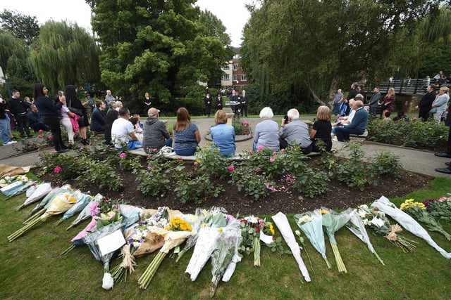 People gather during the proclamation in the Memorial Gardens at Market Harborough on Sunday.