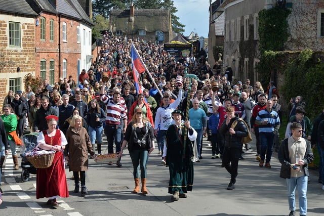 The Hallaton Bottle Kicking parade makes it's way to the church.