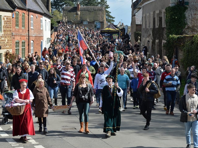 The Hallaton Bottle Kicking parade makes it's way to the church.