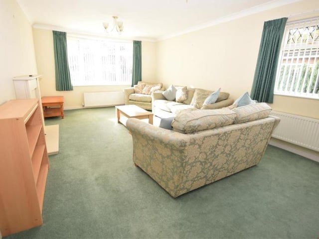 Another look at the lounge, which has plenty of space to incorporate a dining area. The room is also decorated with coving to the ceiling.