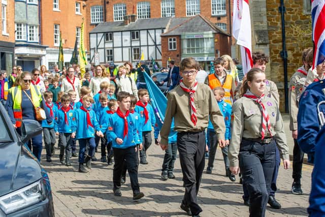 The scouts parade through Harborough town centre.