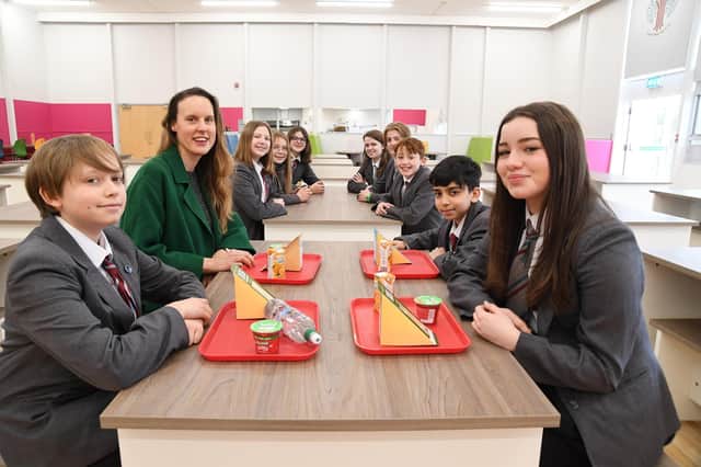 Frances Quinn tries out the new dining hall at Welland Park Academy with students.
PICTURE: ANDREW CARPENTER