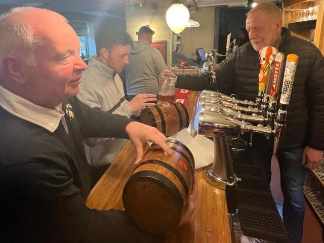 Committee chairman Phil prepares one of the 'bottles' which are filled with beer and sealed with wax.