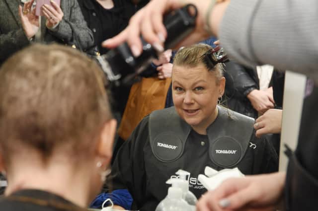 Sophie Williams during the headshave at Toni & Guys in St Mary's Place Market Harborough.