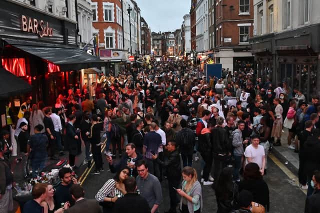 Crowds celebrate the reopening of pubs in Soho, London on 4 July. (Credit: Getty Images)