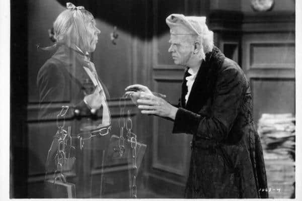 Reginald Owen with ghost in a scene from the film 'A Christmas Carol', 1938. (Photo by Metro-Goldwyn-Mayer/Getty Images)