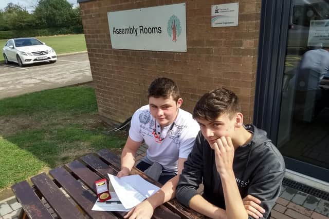 Charlie Power (left) and Nathan Baykut discuss their results at Welland Park Academy, Market Harborough.