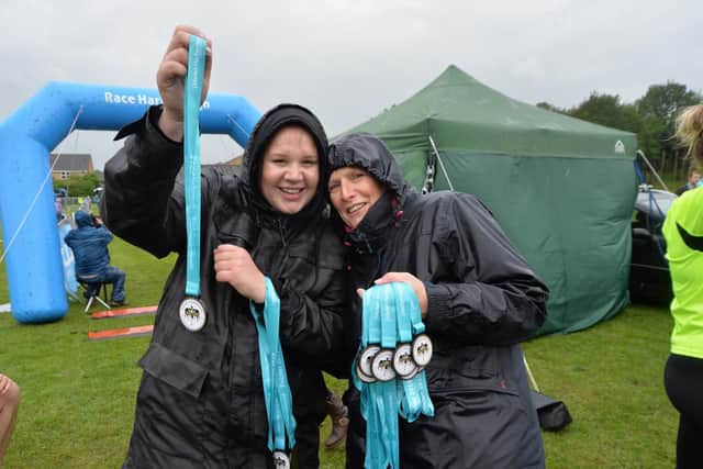 Abi Freer and Helen Lawton of Market Harborough Building Society hand out medals. PICTURE: ANDREW CARPENTER
