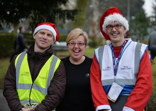 Brian Corcoran, Bev Brown and Roger Pangbourne of park run.
PICTURE: ANDREW CARPENTER NNL-171227-095532005