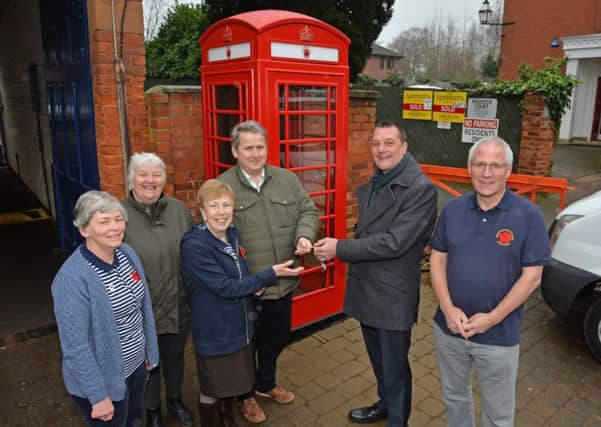 Mark Johnson BT head of pay phone adoption hands over the keys to cllr Phl King deputy leader and Margaret Richards of MHiBV with Jeanette Judah, cllr Barbara Johnson and Peter Eddie with the newly installed phone box on the High Street.
PICTURE: ANDREW CARPENTER NNL-181001-081036005