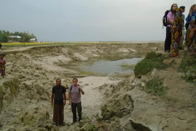 Andy and a local resident at the site of a serious landslide caused by climate change