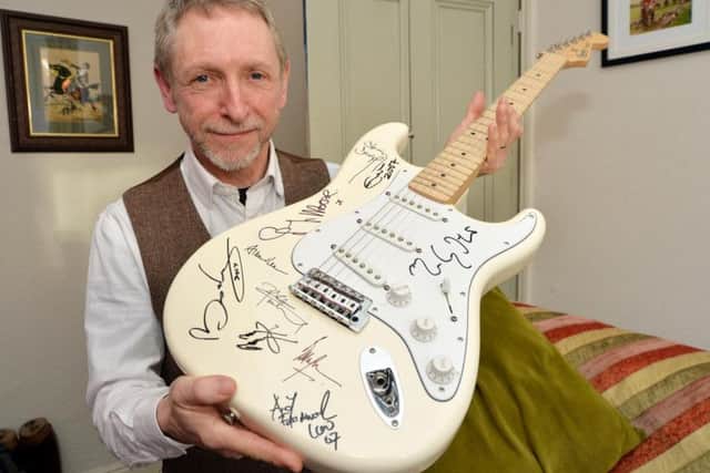 Dave Allen reunited with the music celebrity signed guitar stolen ten years ago. PICTURE: ANDREW CARPENTER