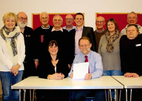 Broughton Astley Parish Council chairman Clive Grafton-Reed and Mrs Debbie Barber, parish manager sign the letter of intent watched by members of the council.