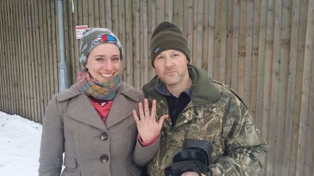 The engagement ring is back on Laurie's finger. She is pictured with Dean McEvaddy, one of the two men who found it.