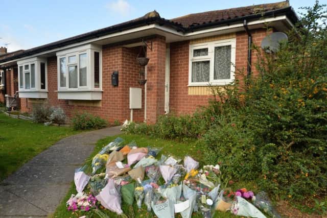 Tributes outside the home of murdered pensioner Jane Hings in Fleckney.
PICTURE: ANDREW CARPENTER NNL-180319-181542005