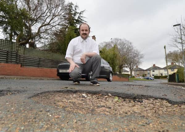 Steve Crick with the pot hole that ruined his tyre on Meadow Street.
PICTURE: ANDREW CARPENTER NNL-180321-104254005