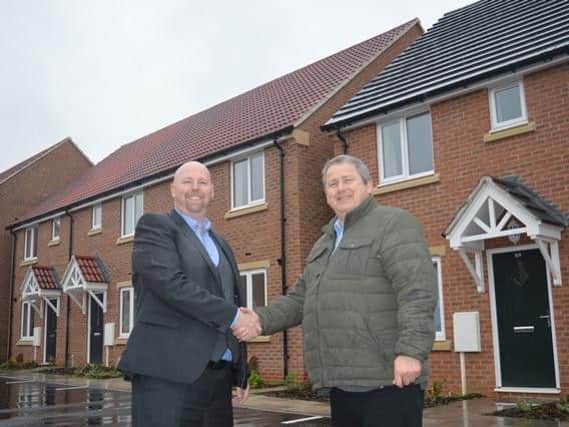 Chris Jones from emh [East Midlands Housing] with Cllr Phil King in front of the attractive affordable homes at the new Mill Fields development in Broughton Astley