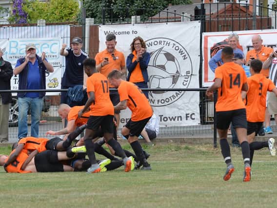 Tendai Daire of Lutterworth Town is mobbed by his team mates after scoring the winning goal. Pictures by Andrew Carpenter