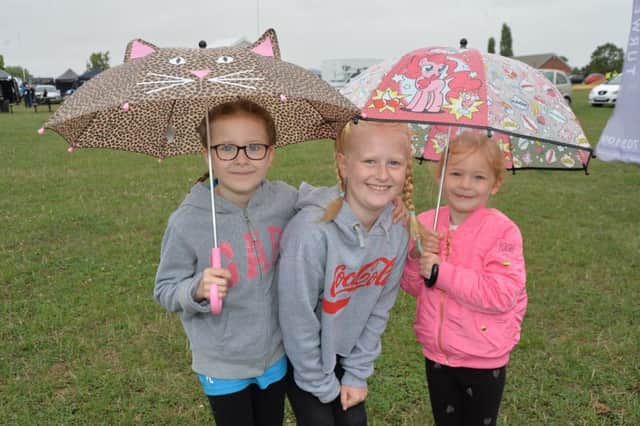 Keeping dry...Poppy Litchfield 8, Phoebe Wallis 10 and Eleanor Litchfield 5.
PICTURE: ANDREW CARPENTER NNL-180814-111749005