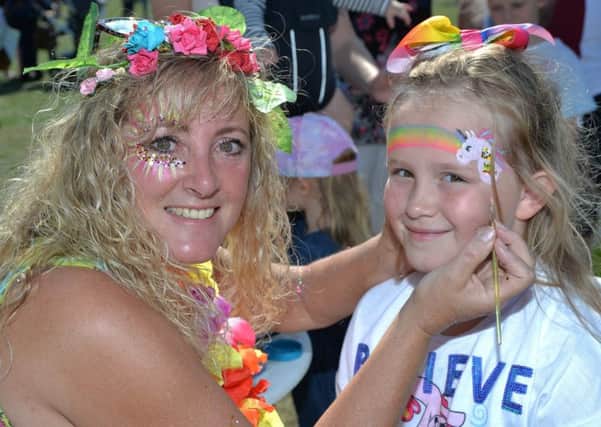 Face painter Rachel Margetts with Megan Marshall.
PICTURE: ANDREW CARPENTER NNL-180409-165914005