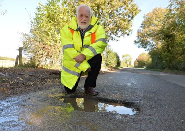 Kibworth resident Dr Kevin Feltham with the repaired leak on Carlton Road in Kibworth Harcourt. PICTURE: ANDREW CARPENTER NNL-180310-081119005