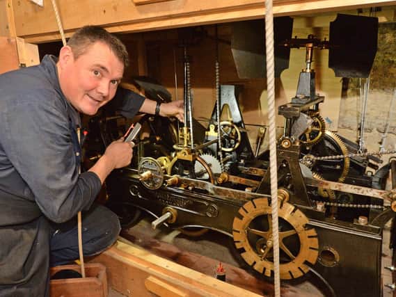 Stuart Morrison of the Cumbria Clock Company repairing the St Dionysius clock. PICTURE: ANDREW CARPENTER