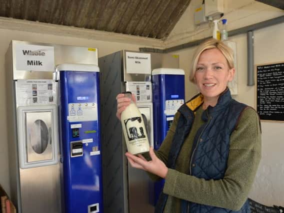 Caroline Barbour with the milk machines in Burton Overy. PICTURE: ANDREW CARPENTER