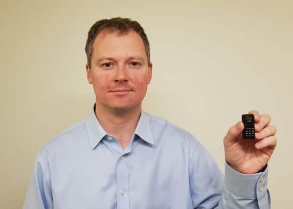 Neil O'Brien MP with one of the tiny phones