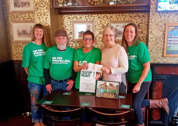 Stepping out...centre, Carole Tilley presents the cheque to Eunice Loney Chairman of Market Harborough Group of Macmillan Cancer Support at the Nags Head with some of the friends who took part. NNL-191101-100020005