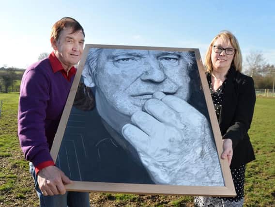 Mike Rickman with a portrait of his late brother Alan Rickman during the presentation of 10,500 to Ali Stunt founder and chief executive of Pancreatic Cancer Action. PICTURE: ANDREW CARPENTER